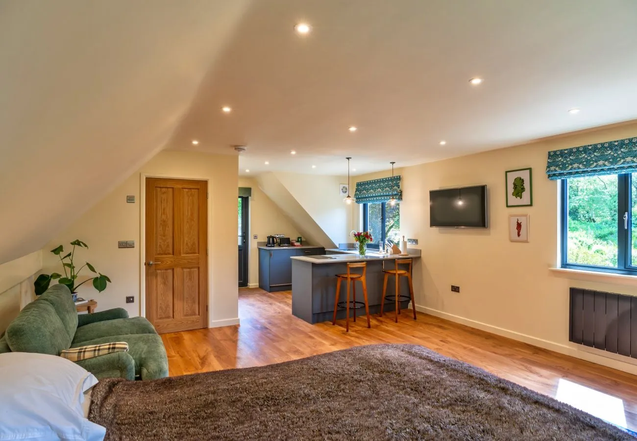 Bright open plan living area with oak floor and doors onto the garden