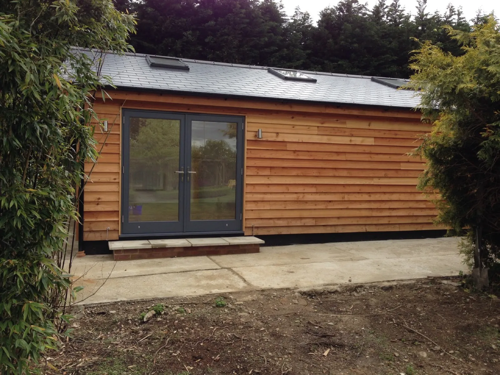 Oak clad garden studio french doors