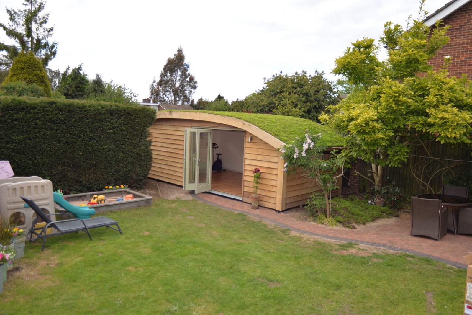 Oak framed garden room curved green roof