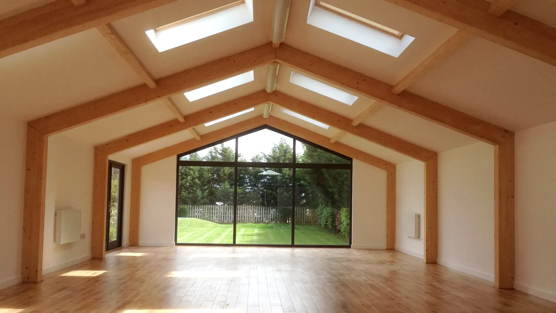 Finished oak framed room with a vaulted ceiling, rooflights and a glazed gable end